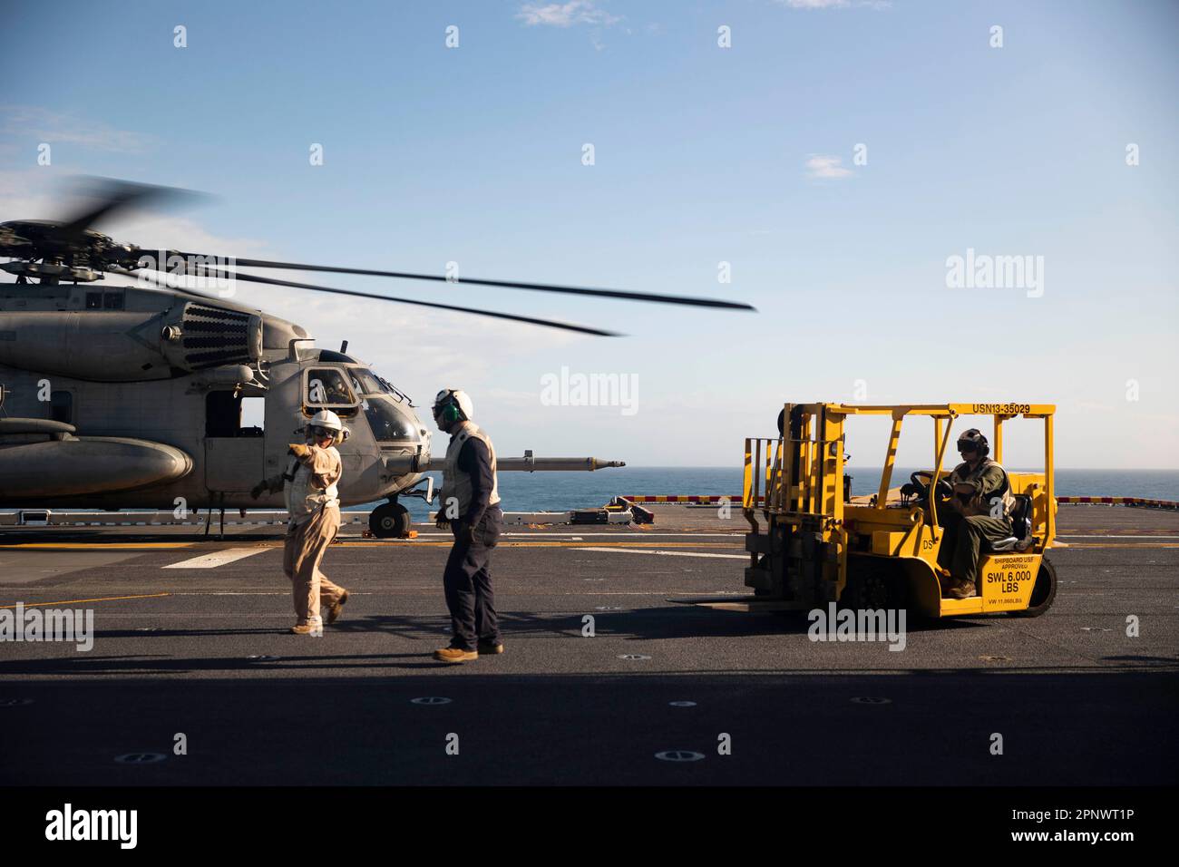 230414-N-HA192-1220 ATLANTIC OCEAN (April 14, 2023) Wasp-class amphibious assault ship USS Bataan (LHD 5) Combat Cargo Marines retrieve cargo from a CH-53E Super Stallion, assigned to Marine Medium Tilt Rotor Squadron (VMM) 162 (reinforced), April 14, 2023. Bataan is the flagship for Commander, Amphibious Squadron EIGHT (PHIBRON 8) and is currently underway for the Bataan Amphibious Ready Group and 26th Marine Expeditionary Unit exercise (ARGMEUEX). The exercise enhances joint integration, lethality and collective capabilities of the Navy-Marine Corps team through joint planning and execution Stock Photo