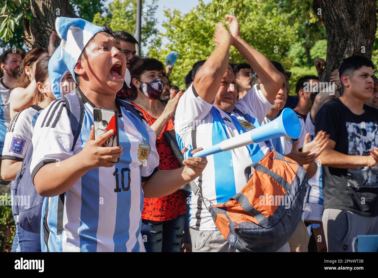 Benjamín González, 13, and his father, Jorge González, cheer for the national team at Parque Centenario in Buenos Aires, Argentina on Dec. 13, 2022, during a match between Argentina and Croatia in the semifinals of the FIFA World Cup. (Lucila Pellettieri/Global Press Journal) Stock Photo
