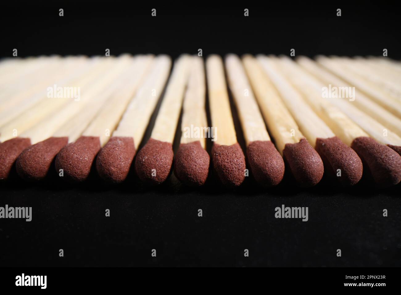 Matches with brown heads in long row ready for lighting up Stock Photo