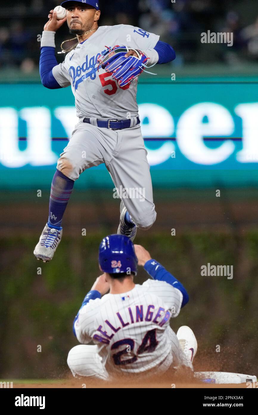 Los Angeles Dodgers shortstop Mookie Betts, top, throws out Chicago Cubs'  Patrick Wisdom at first after forcing out Cody Bellinger at second during  the eighth inning of a baseball game in Chicago