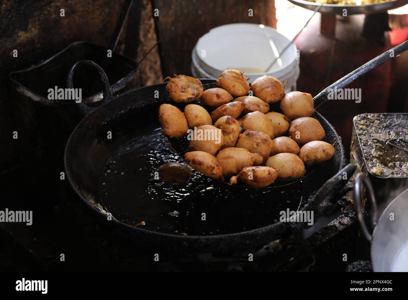 Frying kachori in a Frying Pan at a street food stall , oily food Stock