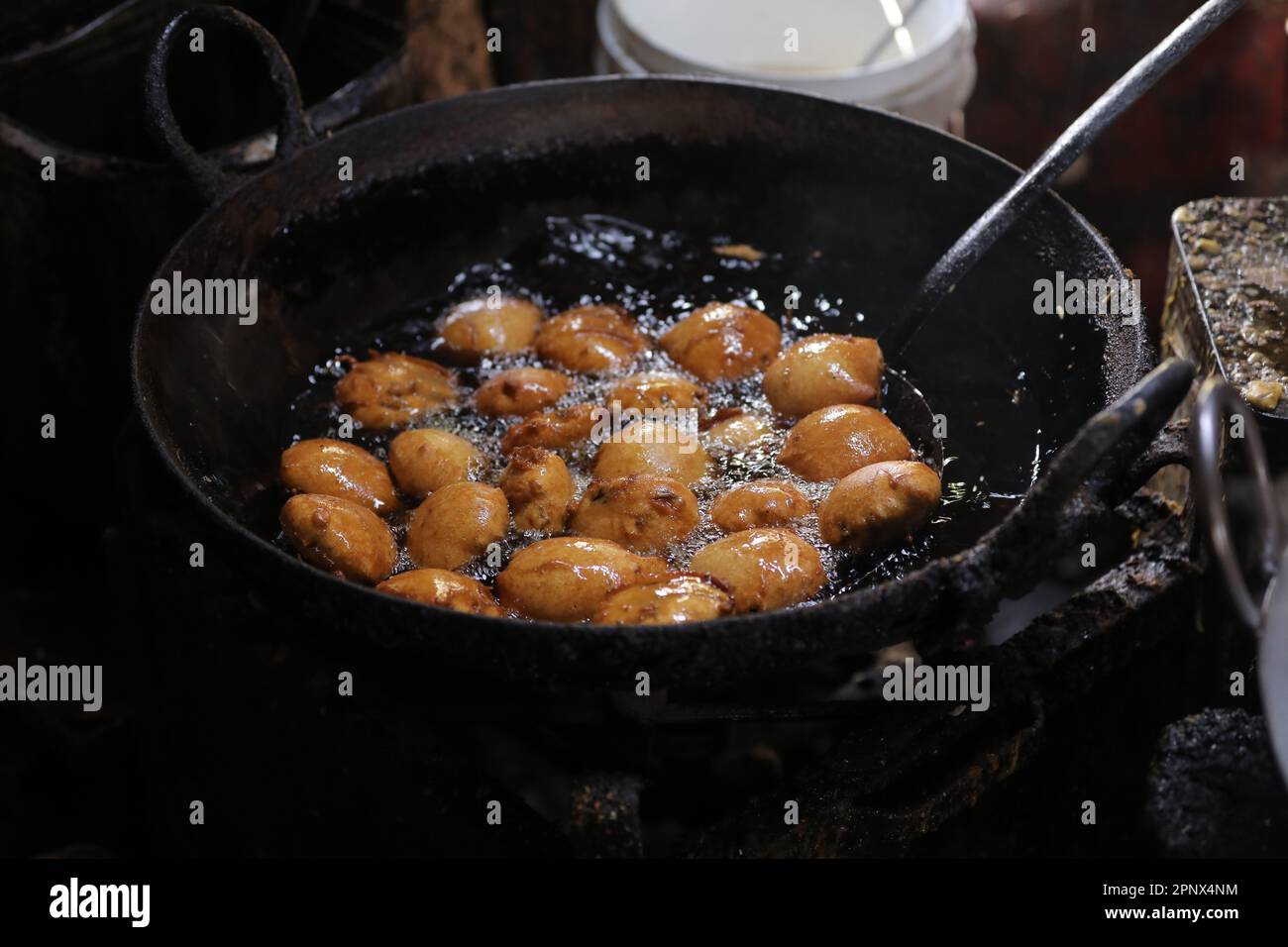 Frying kachori in a Frying Pan at a street food stall , oily food Stock