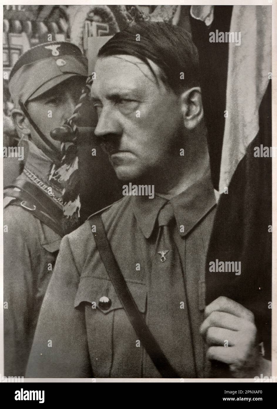 Adolf Hitler holds a standard during the Party Congress of the NSDAP in Weimar Republic. Reproduction of antique photo. Stock Photo