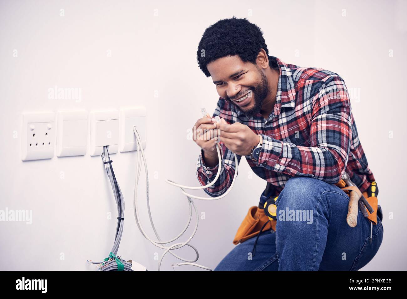 Electric, industry and electrician working on a switchboard with cables