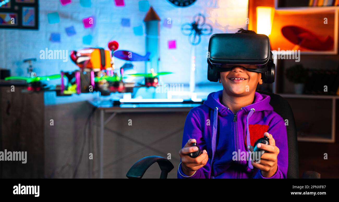 Intelligent indian kid controlling drone by wearing VR or virtual
