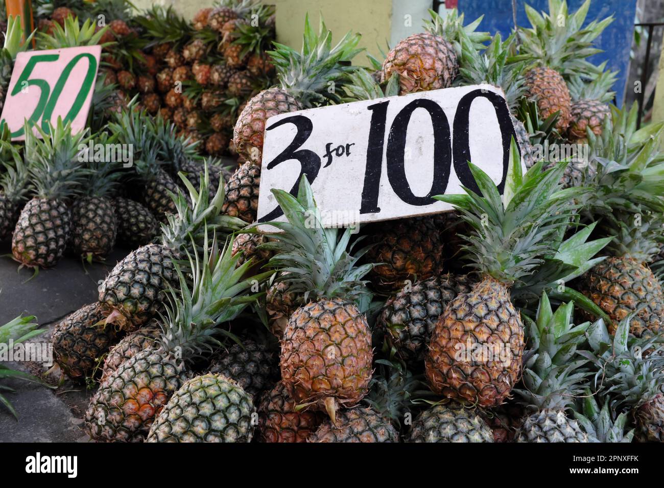 Heap of fresh pineapples sold in beside the street in Calauan, Laguna, Philippines. Stock Photo