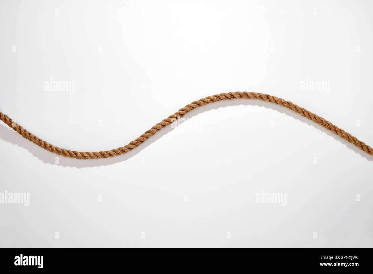 Top view of natural fiber wavy rope placed on white background with shadow Stock Photo