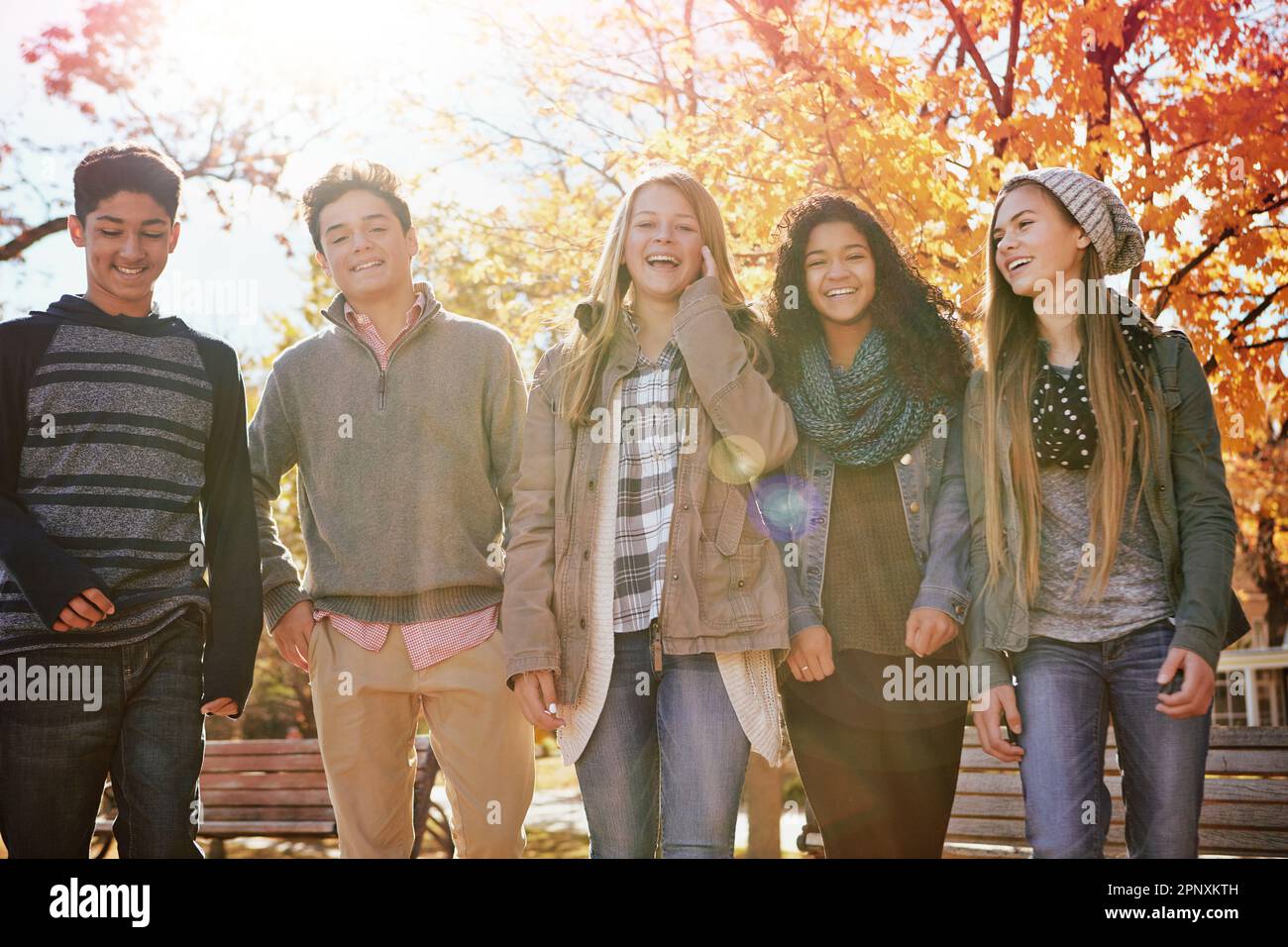Just chillin. a group of teenage friends enjoying an autumn day outside together. Stock Photo