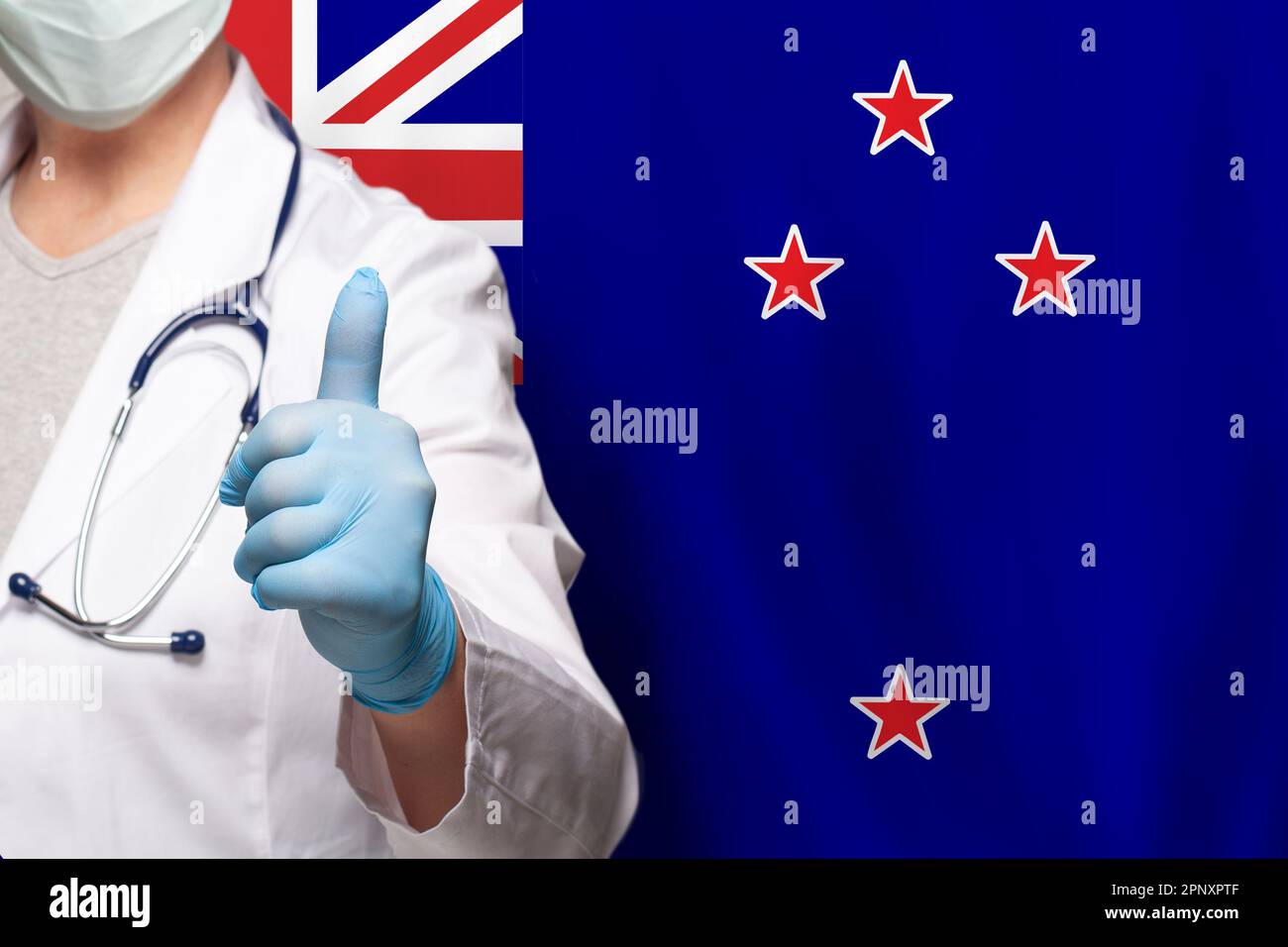 New Zealand doctor's hand showing thumb up positive gesture on flag of