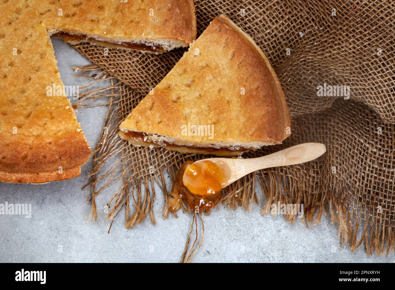 jam tart on rustic table with burlap Stock Photo