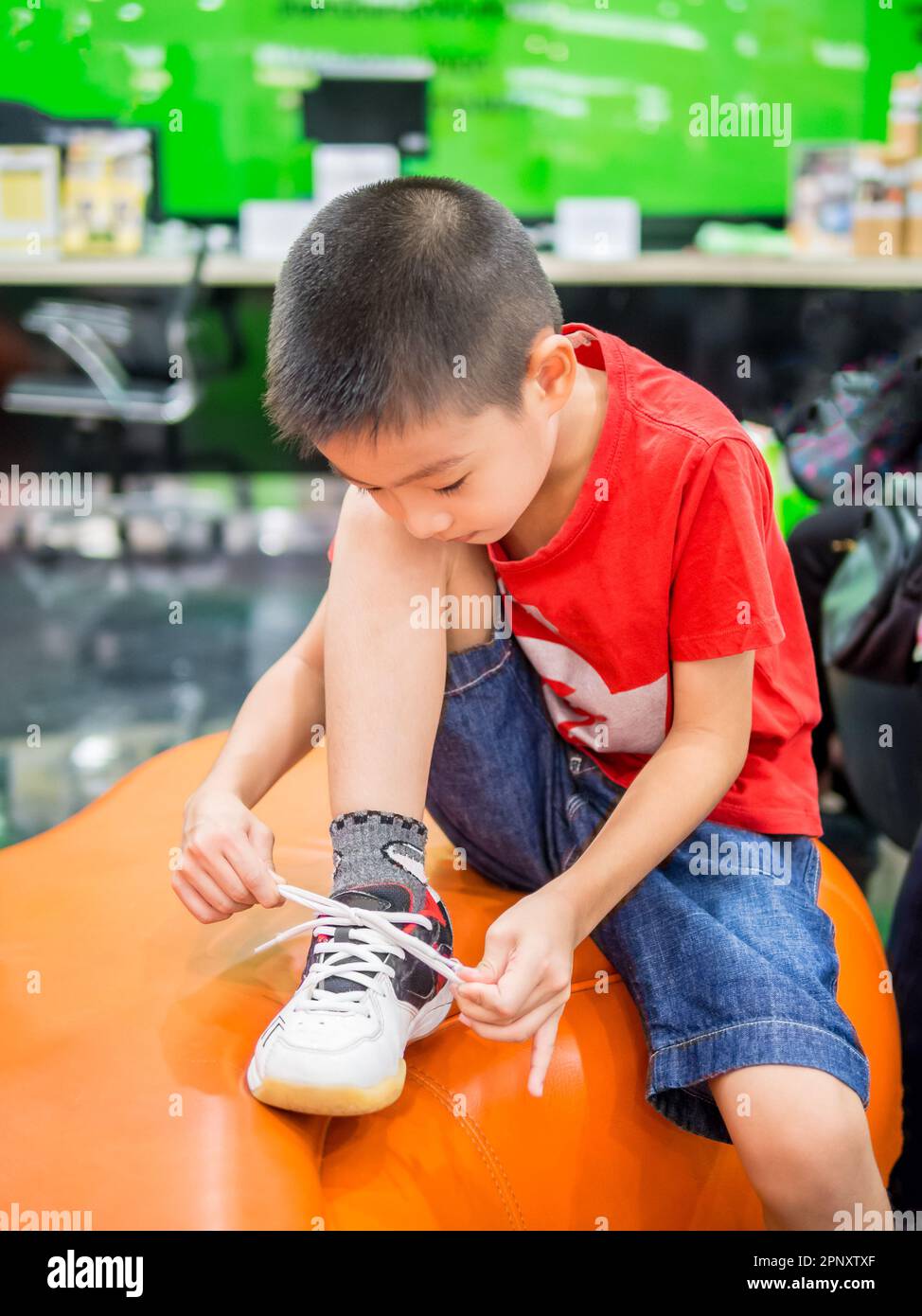 Young boy tying shoelace Stock Photo Alamy