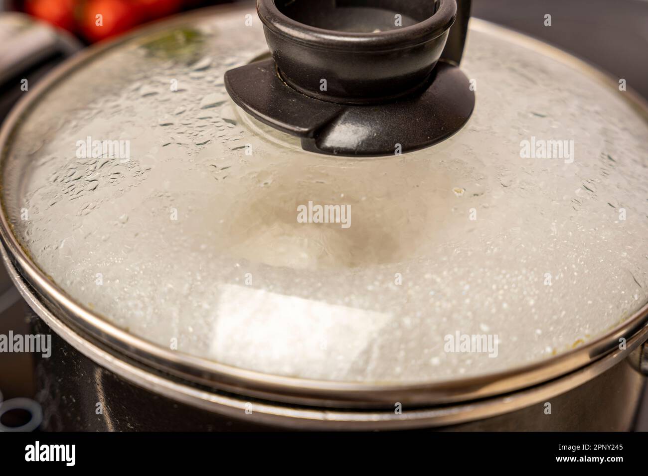 the misted lid of a pot of boiling water Stock Photo Alamy