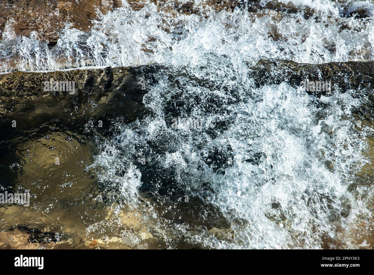 top view of surface of the water agitated on the rocks Stock Photo