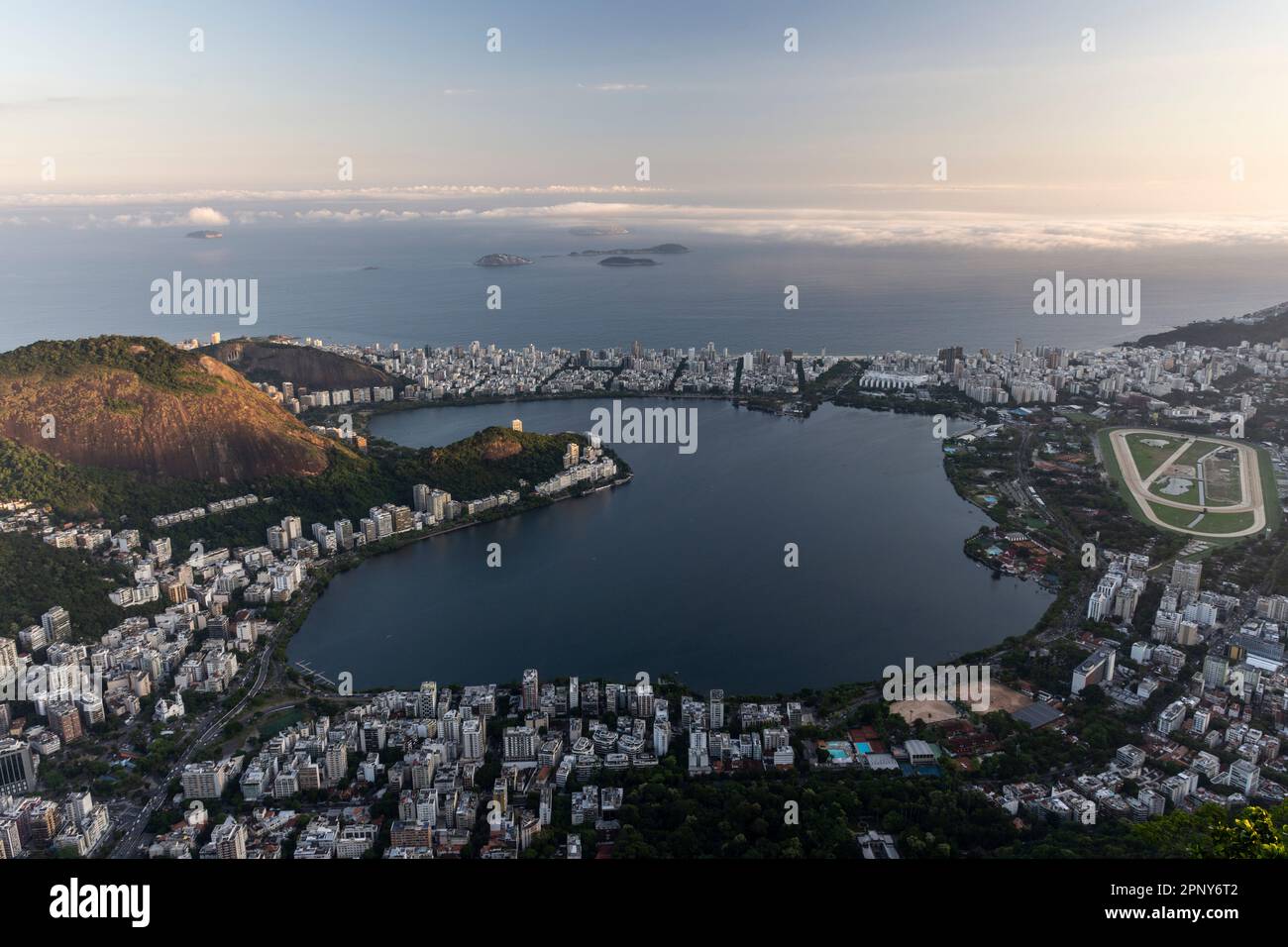 Beautiful view to lagoon city buildings and green rainforest hills ...