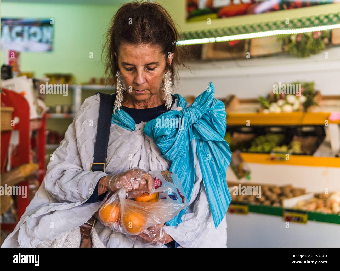 woman with a bag of oranges in her hand in a fruit shop Stock Photo Alamy
