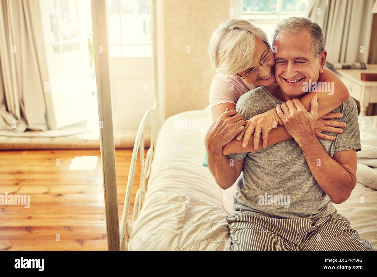 Old couple embracing in bed hi-res stock photography and images - Alamy