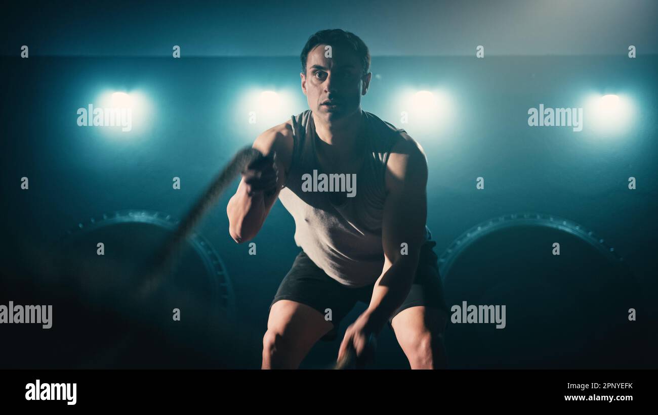 Athlete training using battle ropes Stock Photo - Alamy