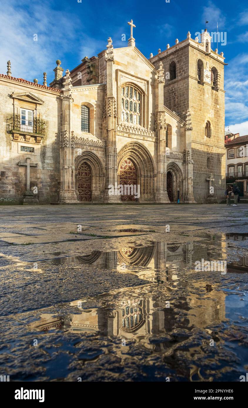 Main facade of the Cathedral of Lamego in Portugal, with it reflected in puddles of rainwater. Stock Photo