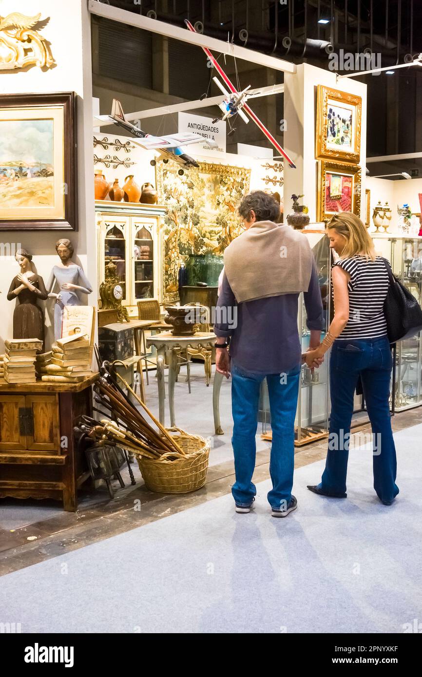 A couple looking at walking sticks on sale at the Antik Passion ...