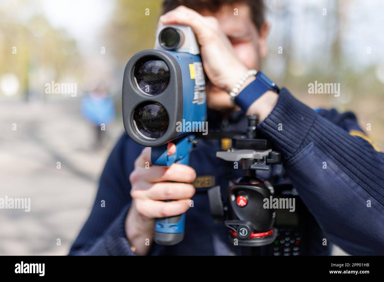 Nuremberg, Germany. 21st Apr, 2023. A police officer looks through a