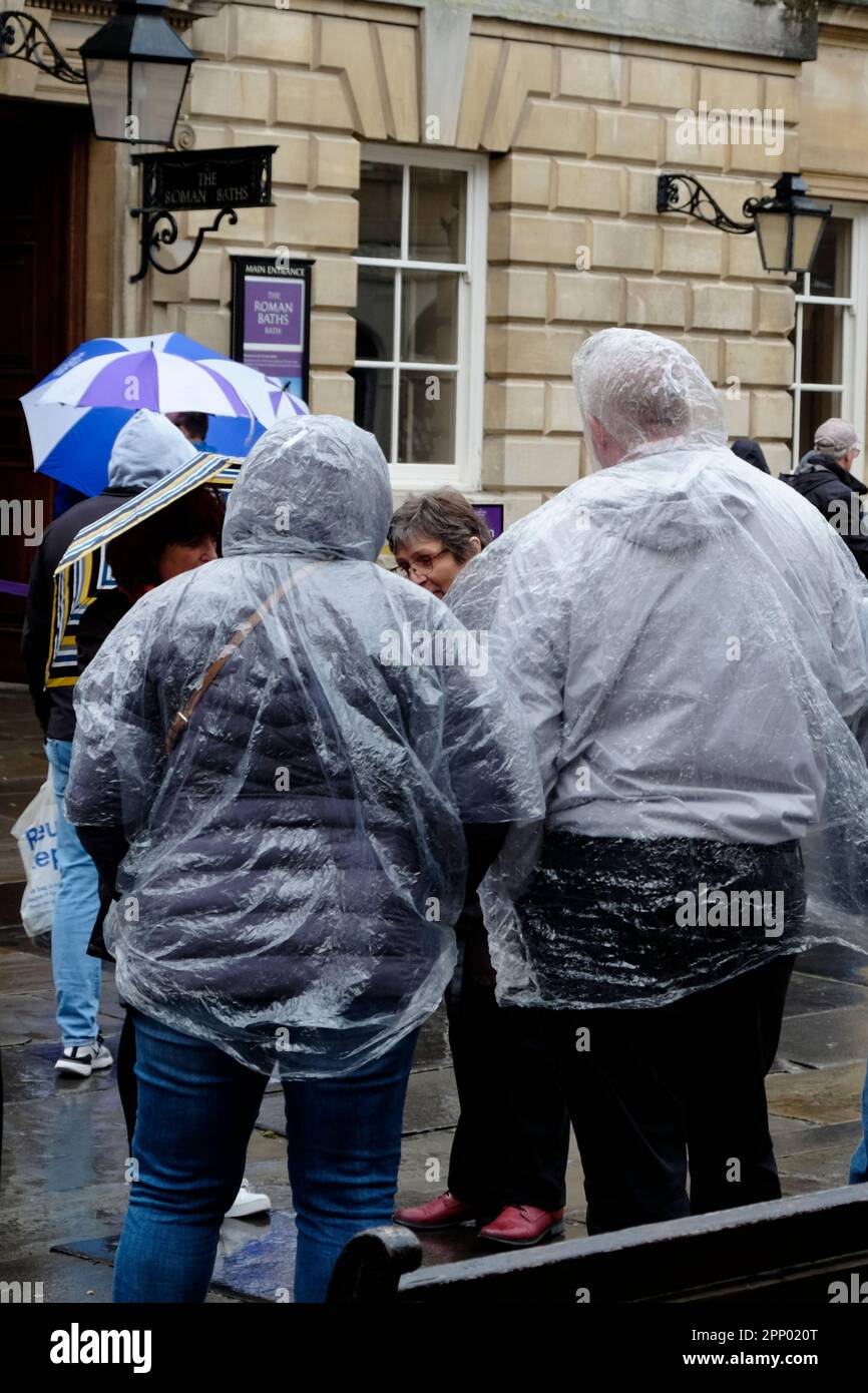 Bath, UK. 21st Apr, 2023. Visitors dressed for the rain go on a walking