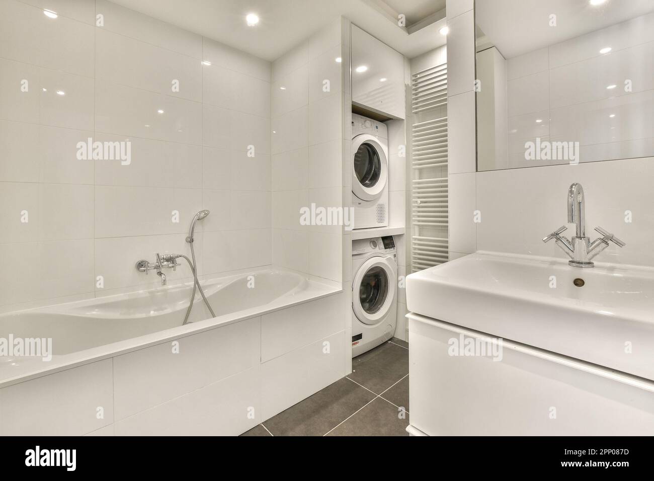 a laundry room with two sinks and a washer in the corner next to the sink is a washing machine