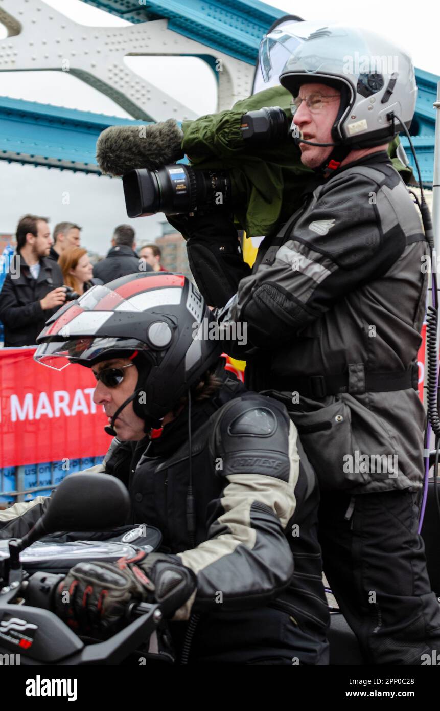 Motorcycle camera crew following the Virgin Money London Marathon 2015 crossing Tower Bridge, UK