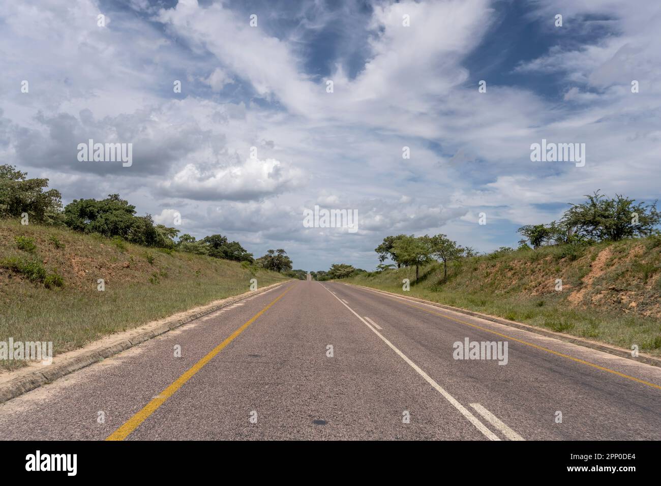 landscape with  R40 road going uphill in hilly countryside near Timbavati, shot in bright summer light , Mpumalanga, South Africa Stock Photo
