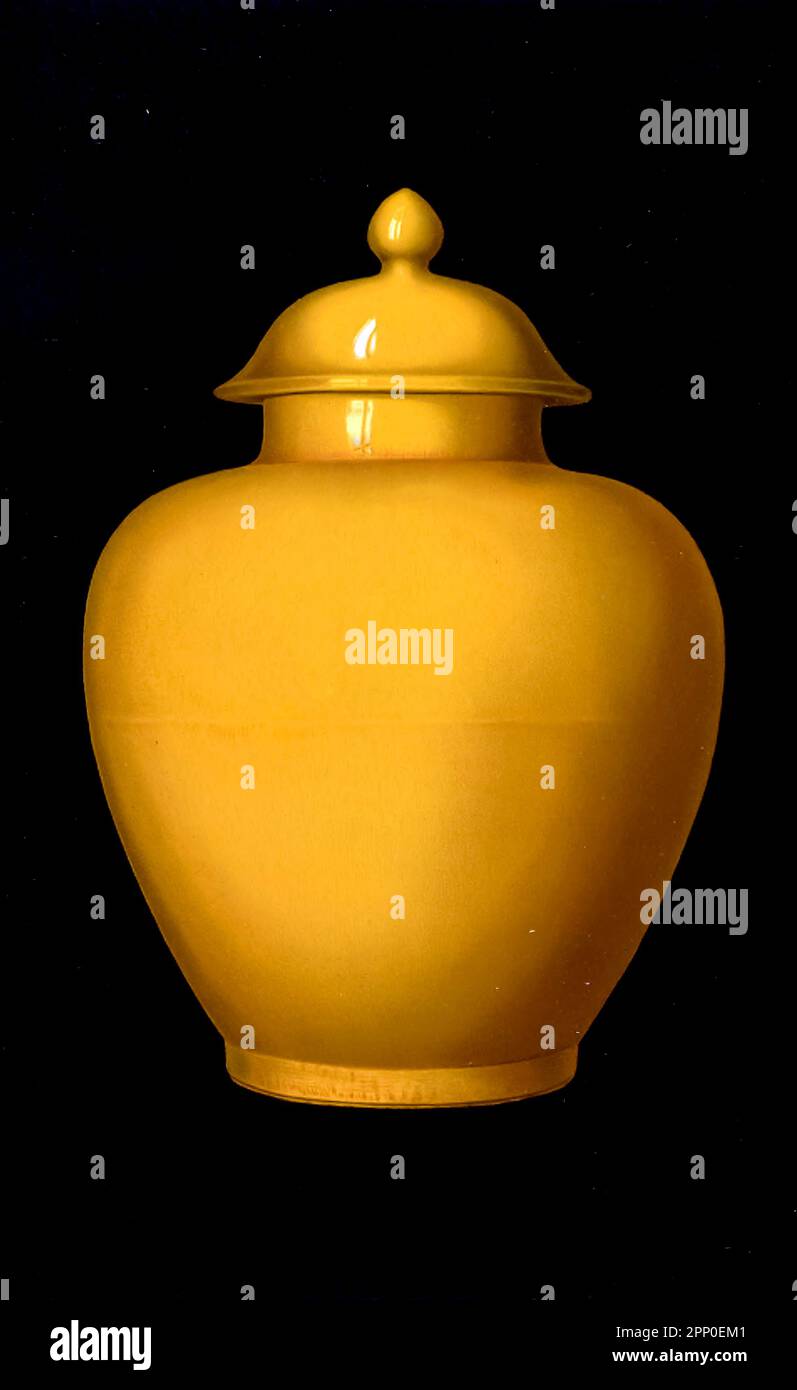 IMPERIAL YELLOW JAR. (Kuan), nine inches high without the cover, enameled with a monochrome glaze of imperial yellow. The faint horizontal line in the middle indicates that the jar was originally fashioned upon the wheel in two pieces Made in the reign of K'ang-hsi (1662- 1722), of the great Ch'ing dynasty From the book ' ORIENTAL CERAMIC ART COLLECTION OF William Thompson Walters ' Published in 1897 Stock Photo