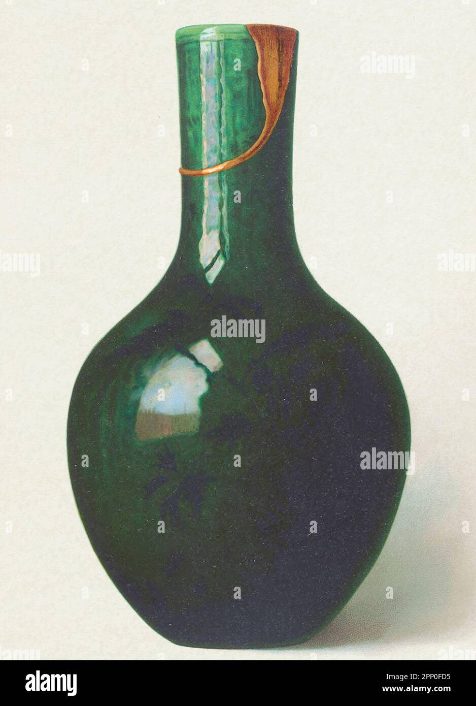 DECORATED VASE OF CAMELLIA-LEAF GREEN. (P'ing), 17 inches high, bottle-shaped, with bulging body and wide neck, painted with a floral decoration of shaded black , invested with a monochrome iridescent glaze of deep camellia-leaf green. The rim, which has been broken, has been mended in fapan with gold lacquer belongs to the reign of K'ang-hsi (1662-1722) From the book ' ORIENTAL CERAMIC ART COLLECTION OF William Thompson Walters ' Published in 1897 Stock Photo