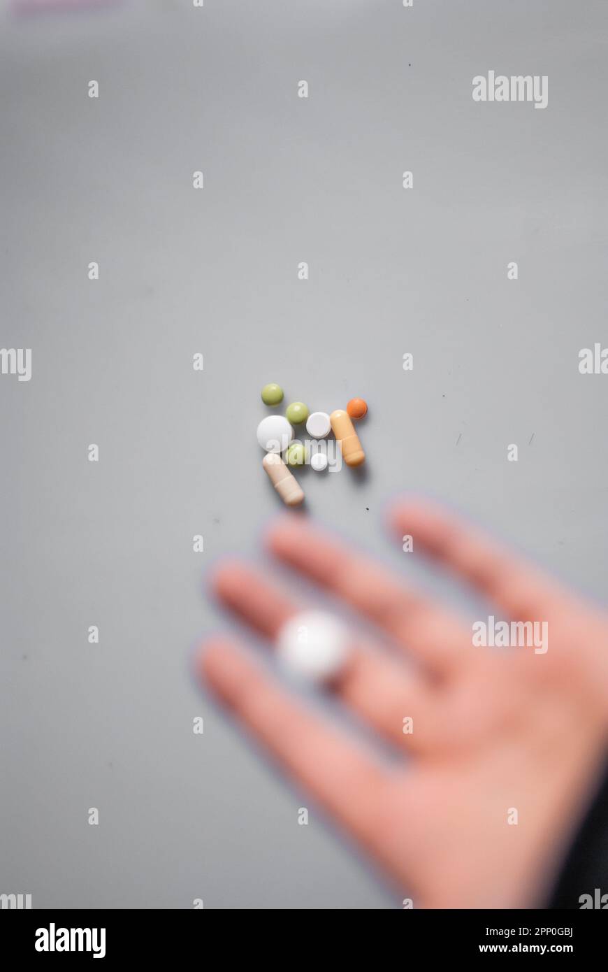 View of pills and hand with pill on the white background Stock Photo
