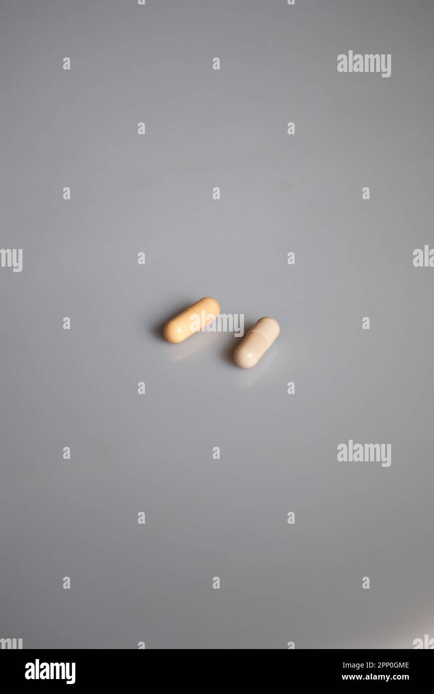 View of two pills on the white background Stock Photo