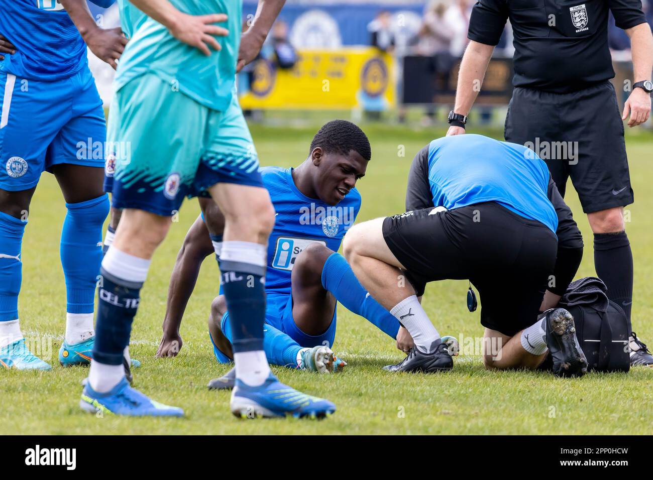 Colin Oppong is treated for an ankle injury during a football match against Stalybridge Celtic at Gorsey Lane, Warrington, Cheshire Stock Photo