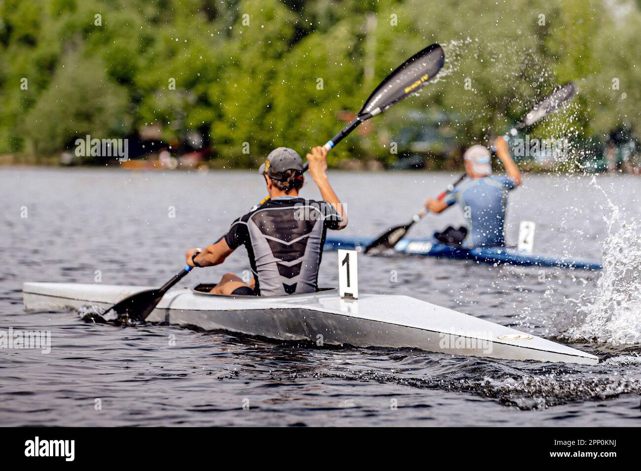 two male athlete kayaker on kayak single rowing kayaking championship race, sports summer games Stock Photo