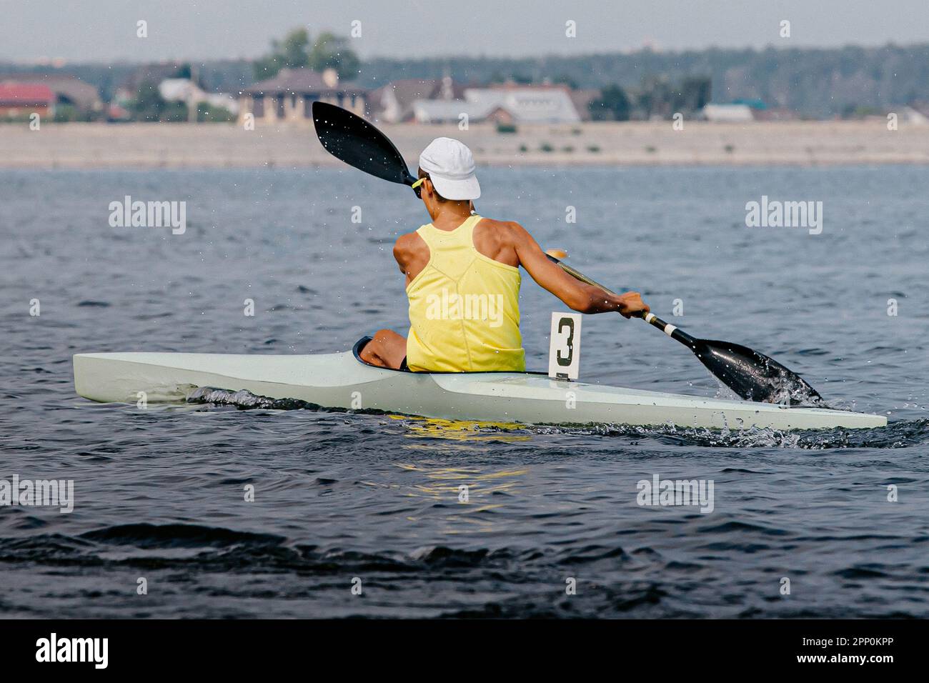 rear view male athlete on kayak single in kayaking competition race, sports summer games Stock Photo