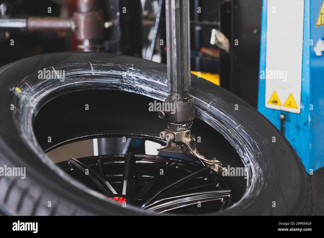 Wheel with tire on tire changing machine in auto repair service Stock