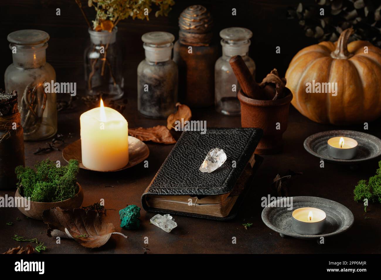 Witchcraft still life concept with potion, spell book, herbs ingredients candles and magical equipment Stock Photo
