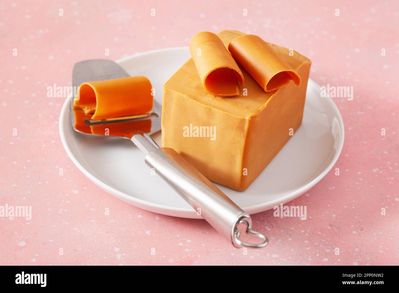 Norwegian brunost traditional brown cheese block and slicer Stock Photo by  duskbabe