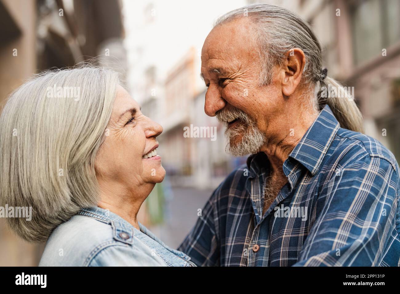 Happy senior couple having tender moments in the city - Elderly people and love relationship concept Stock Photo