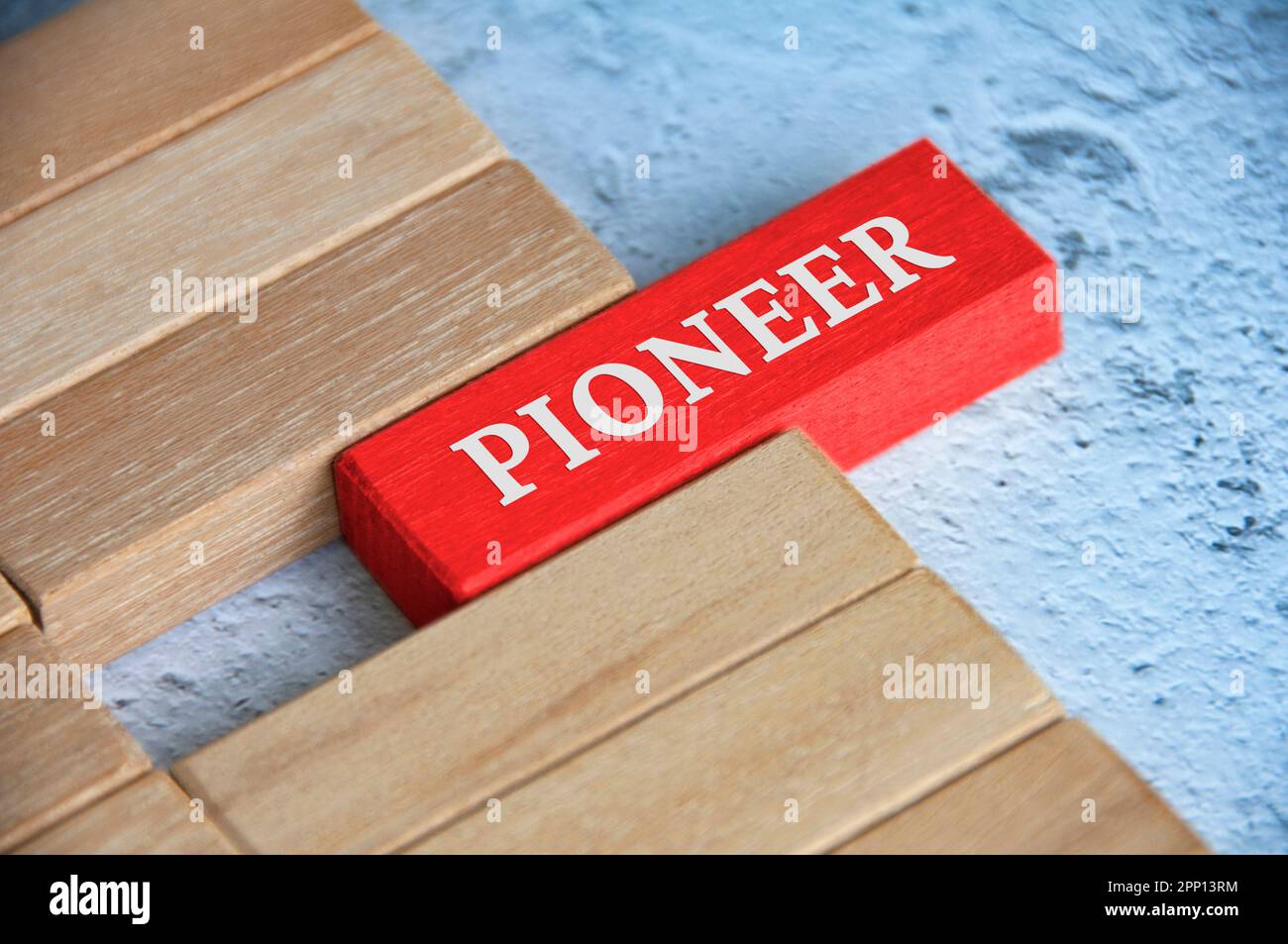 Top view of Pioneer text on red color wooden blocks. Stock Photo
