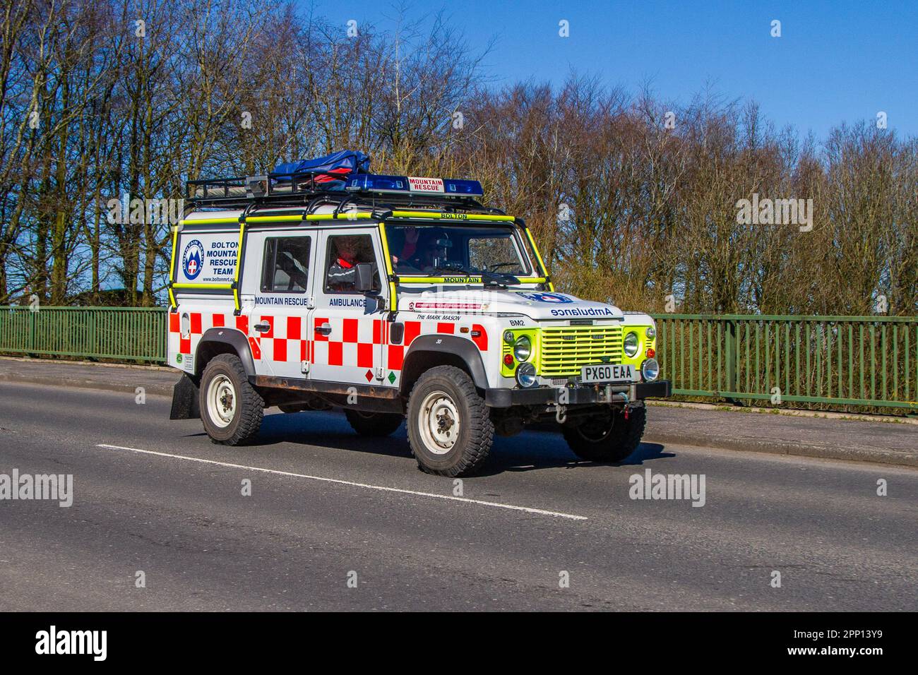 BOLTON Mountain Rescue Team Ambulance 2010 Land Rover Defender 110 Td D/C TD5 White LCV Double Cab Pick Up Diesel 2402 cc; crossing motorway bridge in Greater Manchester, UK Stock Photo