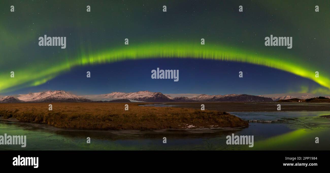 Northern Lights / Aurora borealis / polar lights, weather phenomenon showing natural light display over Hornafjörður in winter, Austurland, Iceland Stock Photo