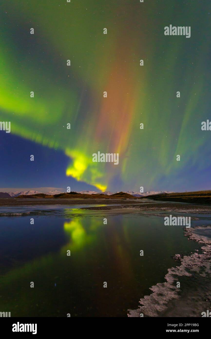 Northern Lights / Aurora borealis / polar lights, weather phenomenon showing natural light display over Hornafjörður in winter, Austurland, Iceland Stock Photo
