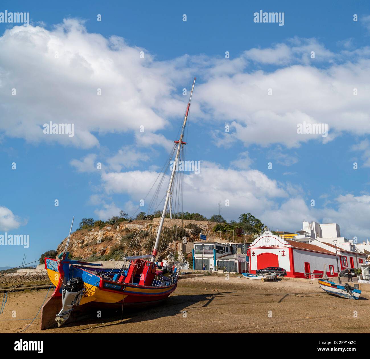 ALVOR, PORTUGAL - 16th APRIL, 2023: Beautiful traditional fishing boat and restored lifeguard station. at the town of Alvor. Stock Photo