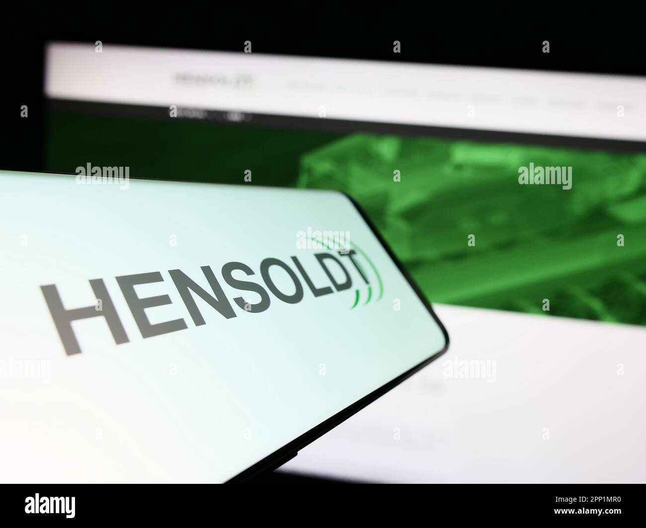 Smartphone with logo of German defense company Hensoldt AG on screen in front of business website. Focus on center of phone display. Stock Photo