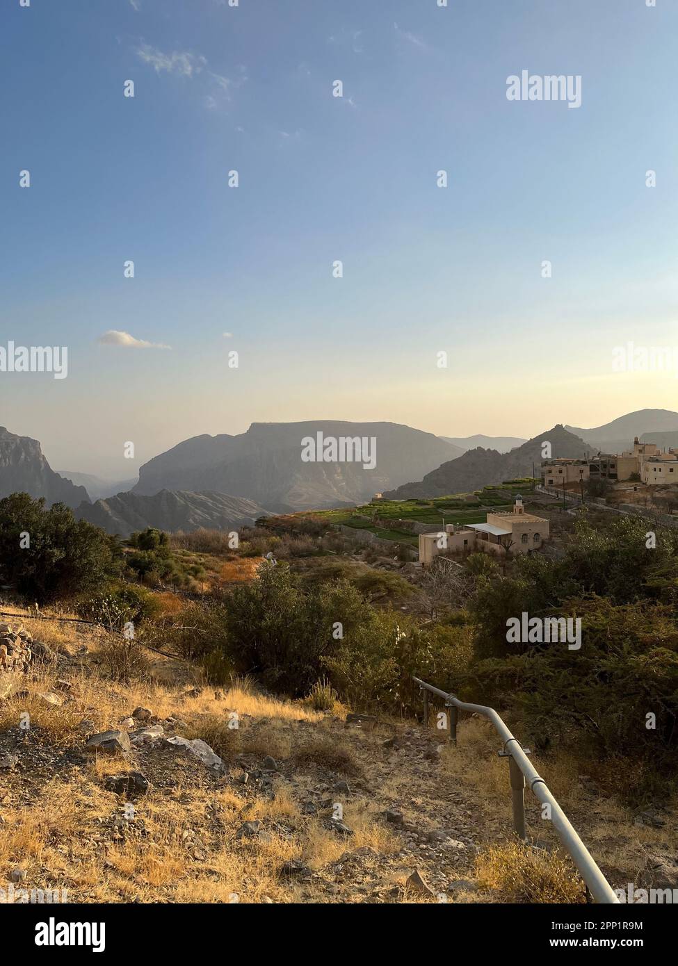 A scenic landscape with trees and foliage on the hillside, with rocky ...