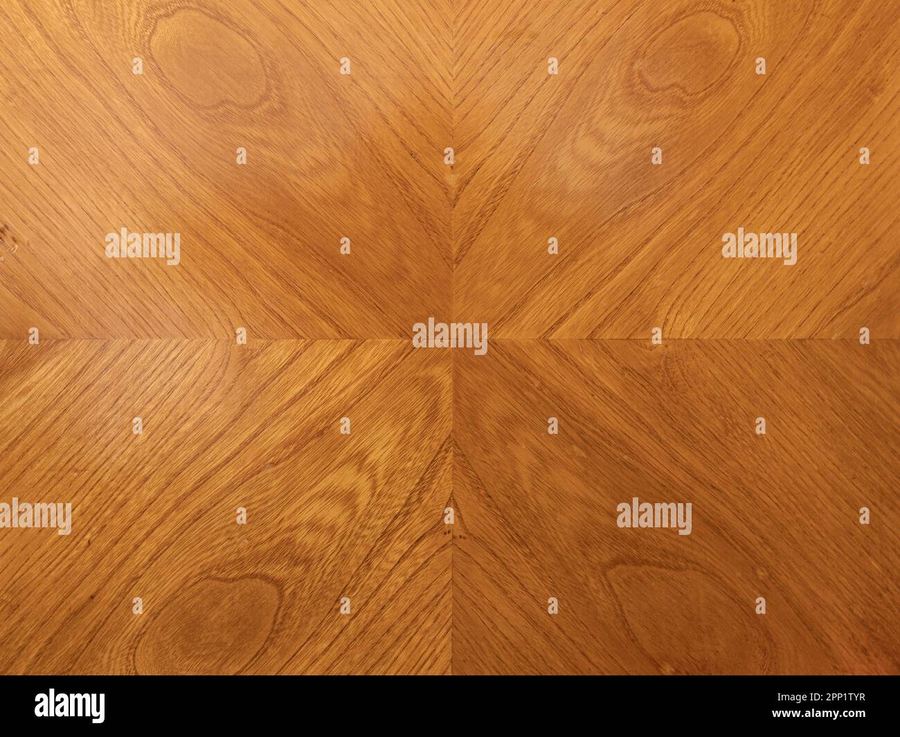 Wood veneer in a symmetric design pattern on an old furniture