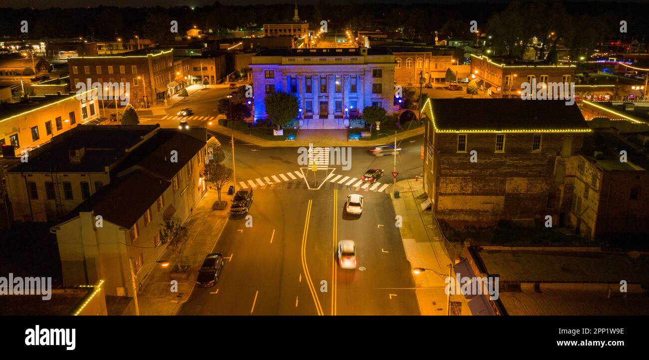 An aerial view of a bustling city street illuminated by street lights ...