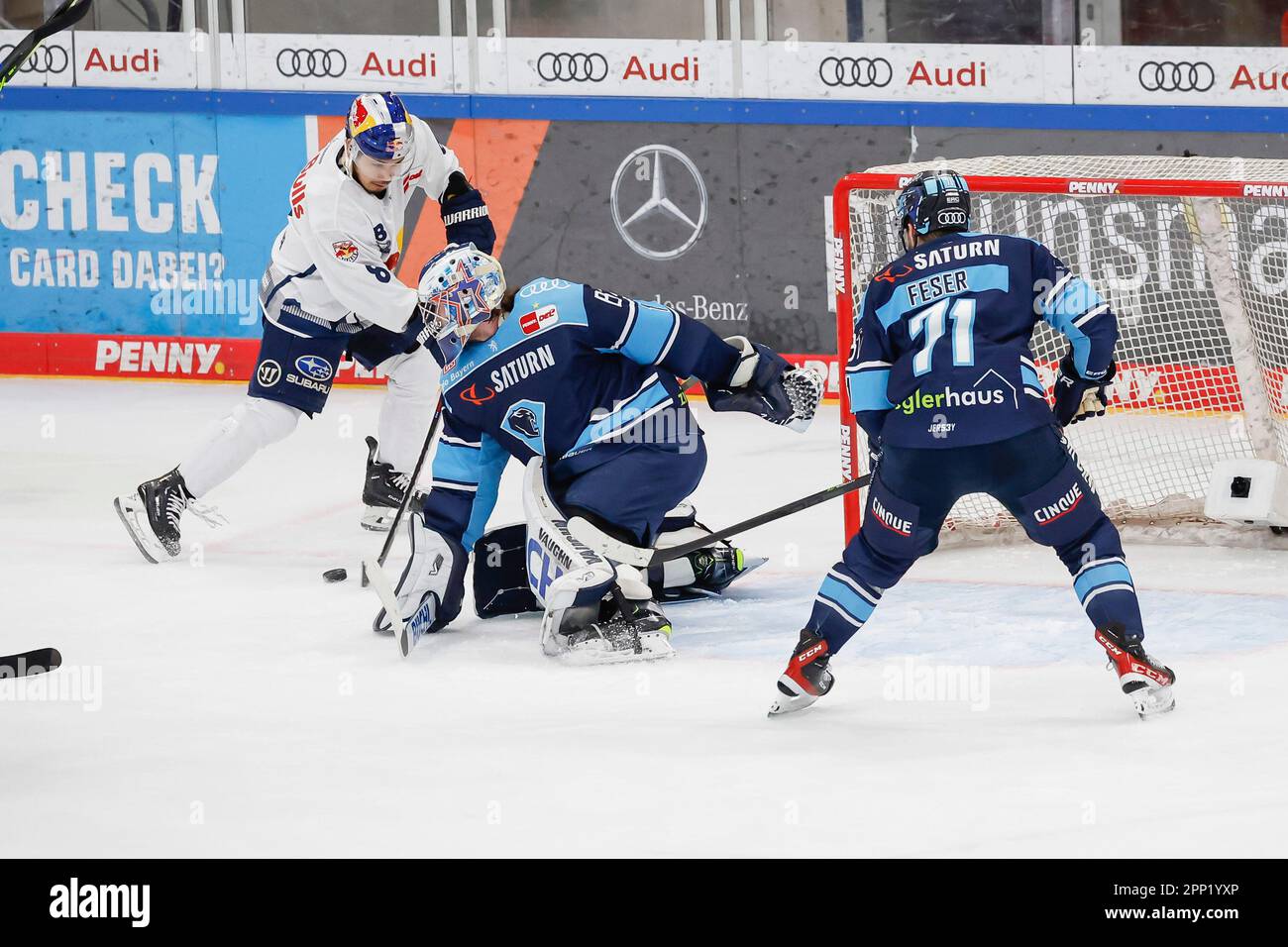 Ingolstadt, Germany. 21st Apr, 2023. Ice hockey: DEL, ERC Ingolstadt - EHC Red Bull Munich, championship round, final, Matchday 4, Saturn Arena. Goalie Kevin Reich (M) of ERC Ingolstadt clears the puck from Austin Ortega (l) of EHC Munich, Justin Feser of ERC Ingolstadt on the right. Credit: Daniel Löb/dpa/Alamy Live News Stock Photo