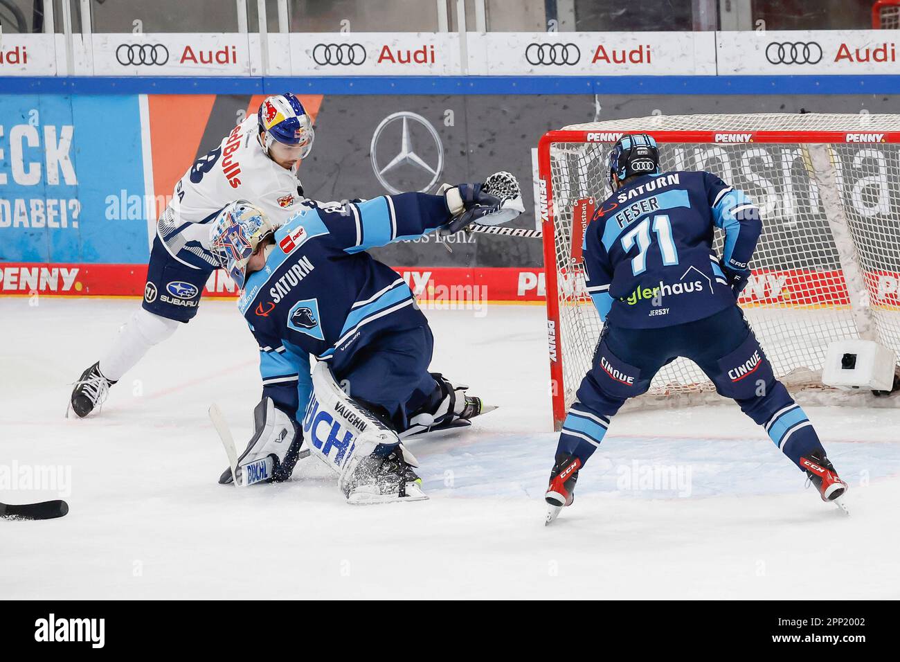 Ingolstadt, Germany. 21st Apr, 2023. Ice hockey: DEL, ERC Ingolstadt - EHC Red Bull Munich, championship round, final, Matchday 4, Saturn Arena. Goalie Kevin Reich (M) of ERC Ingolstadt clears the puck from Austin Ortega (l) of EHC Munich, Justin Feser of ERC Ingolstadt on the right. Credit: Daniel Löb/dpa/Alamy Live News Stock Photo
